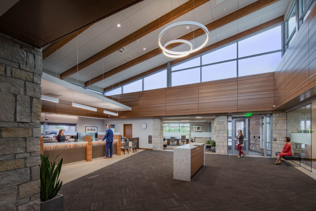 Modern bank branch lobby with layered warm lighting