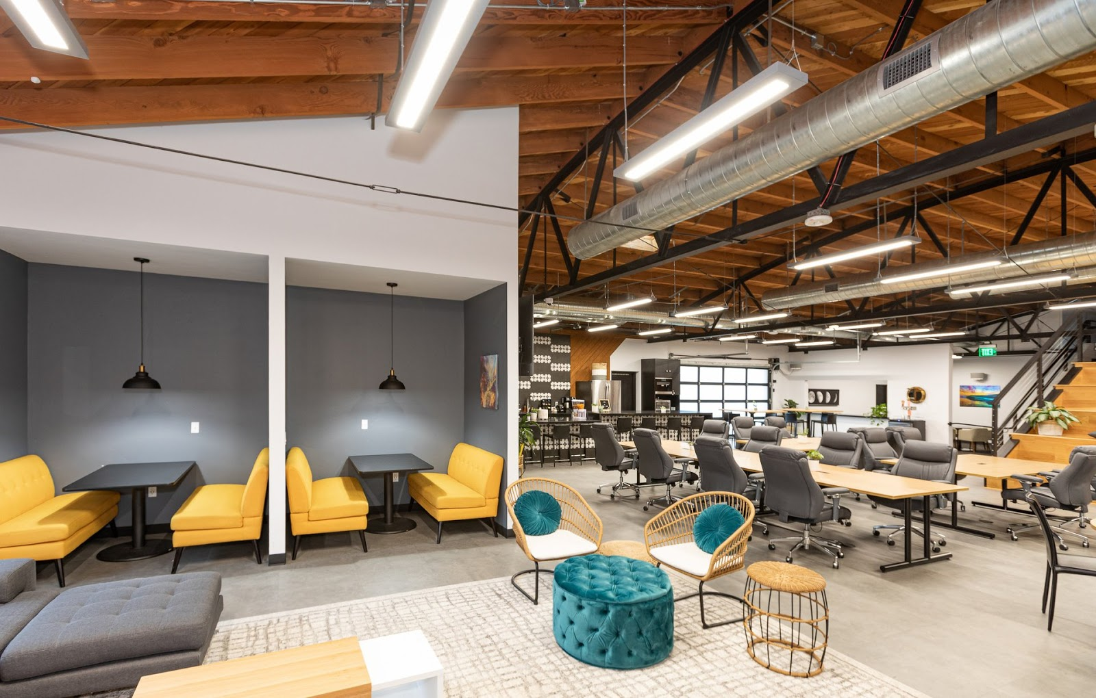 Modern co-working space with open floor plan and pendant lighting