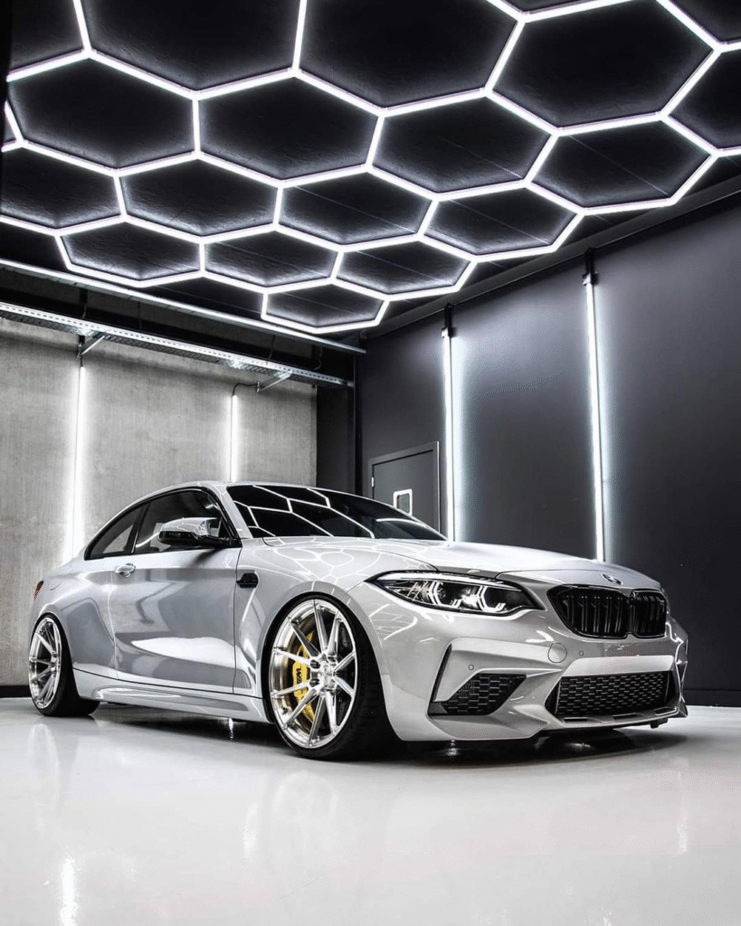 Auto detailing studio with hexagonal LED ceiling lighting system
