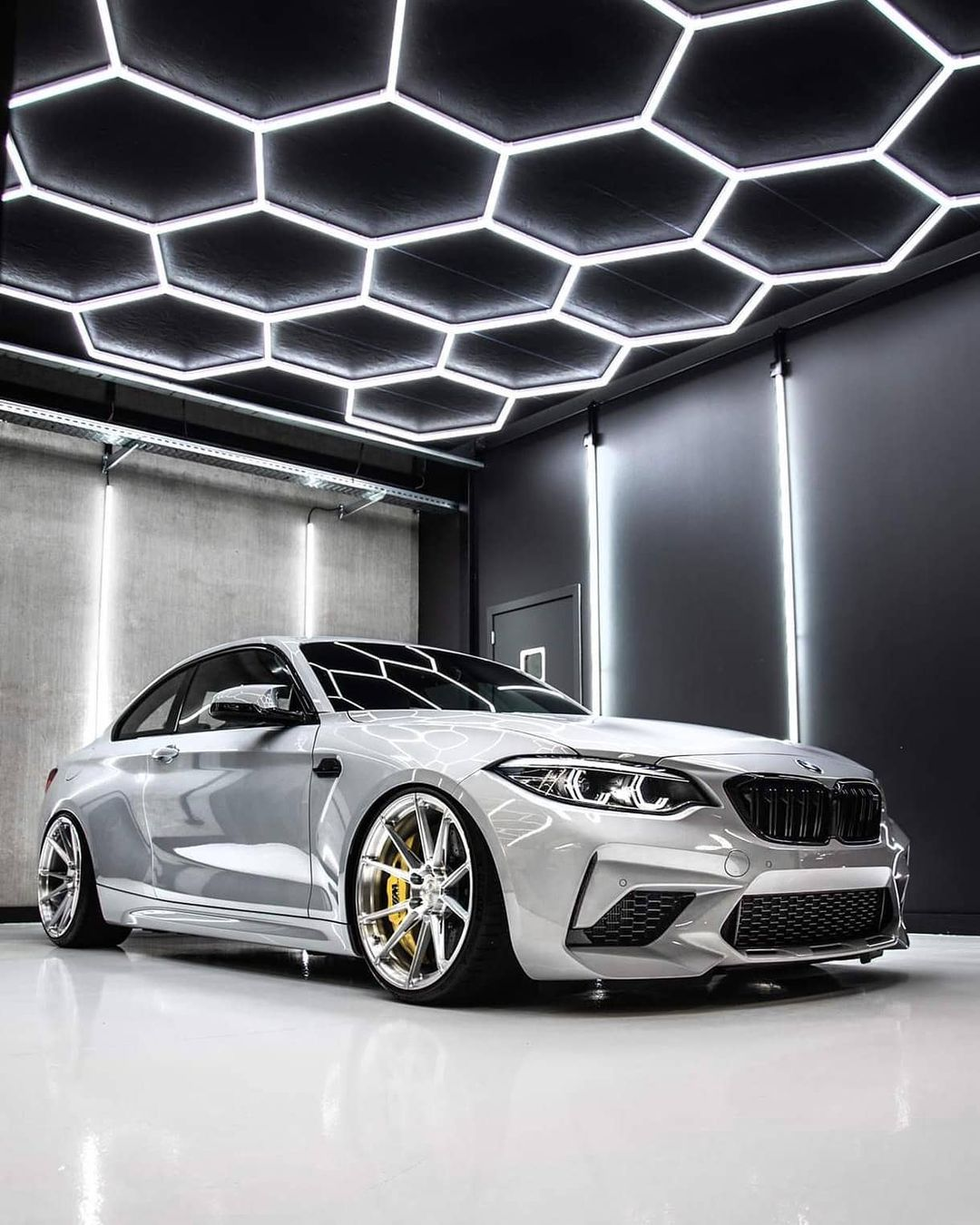 Auto detailing studio with hexagonal LED ceiling lighting system