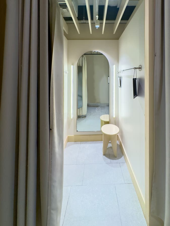 Modern fitting room with vertical side lighting and mirror illumination