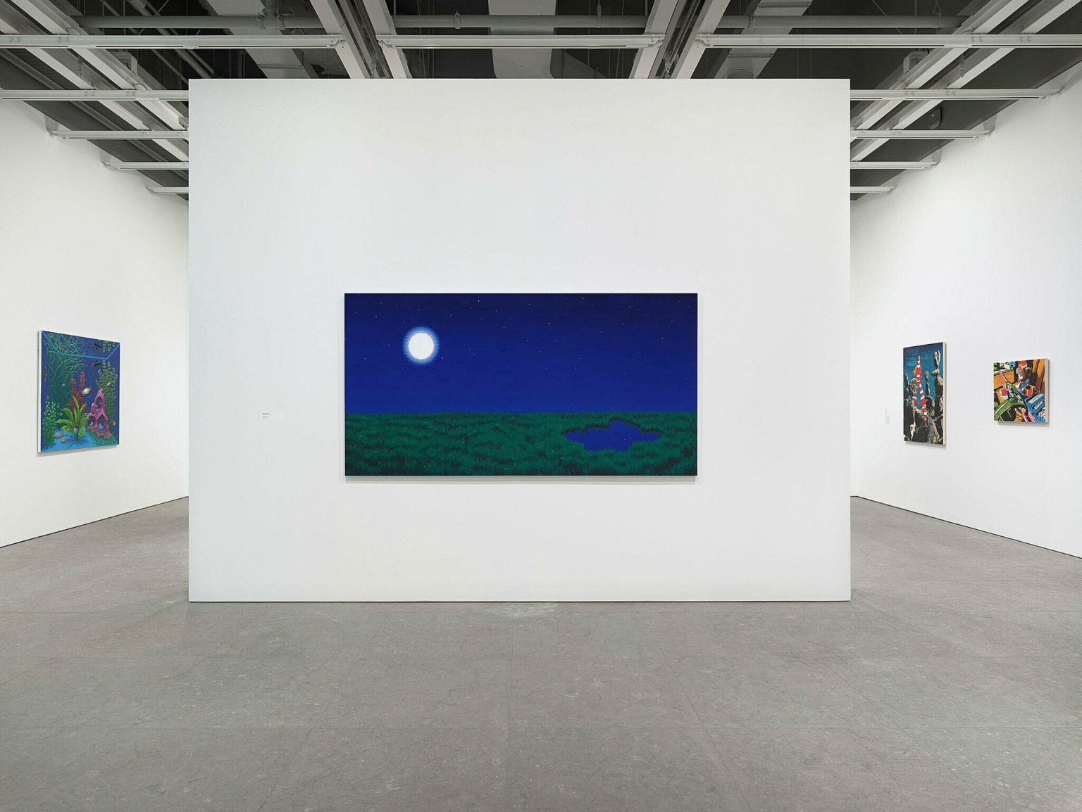 Modern art gallery interior with white walls and track lighting illuminating paintings on display