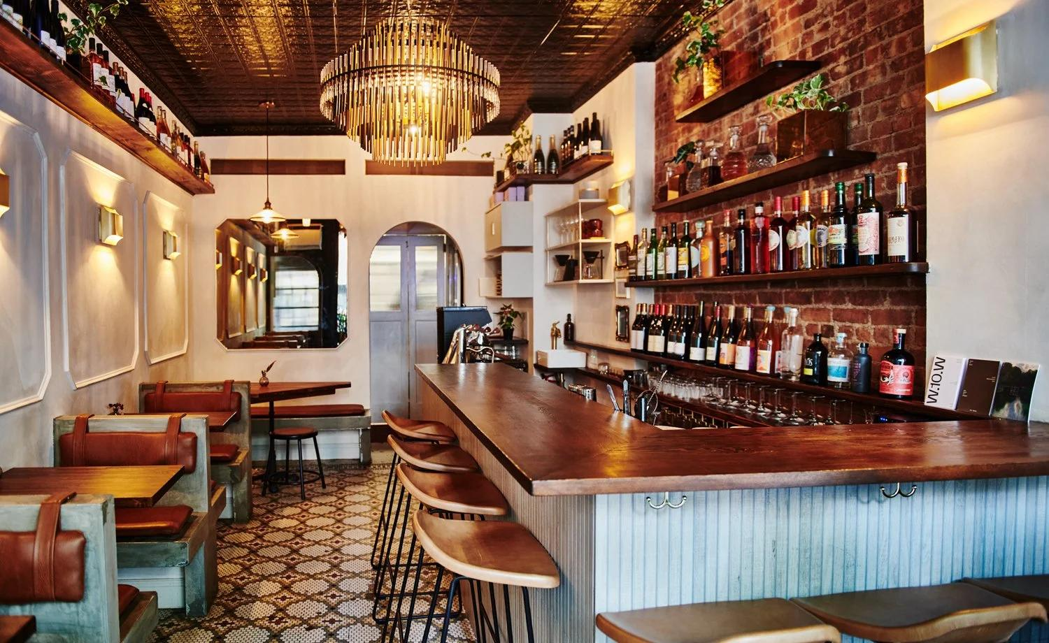 Wine bar interior with layered lighting design for bar counter and display